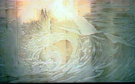 sandblasting of waves crashing on shore